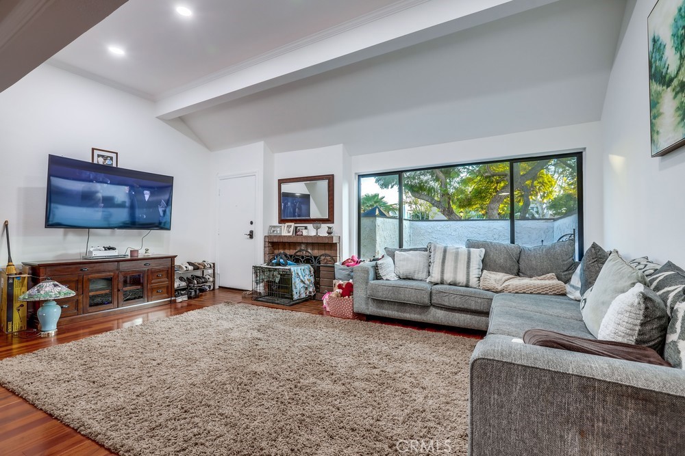 9678 Walker Court Cypress, CA 90630 - Photo 7 of 40 a living room with furniture and a flat screen tv