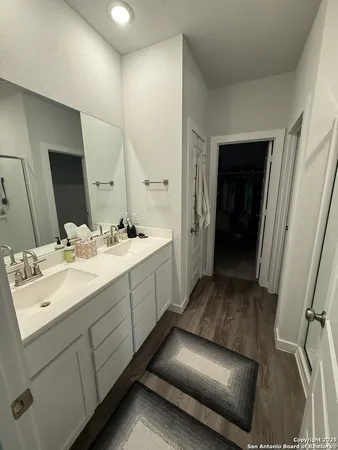 a en suite bathroom with a sink and mirror