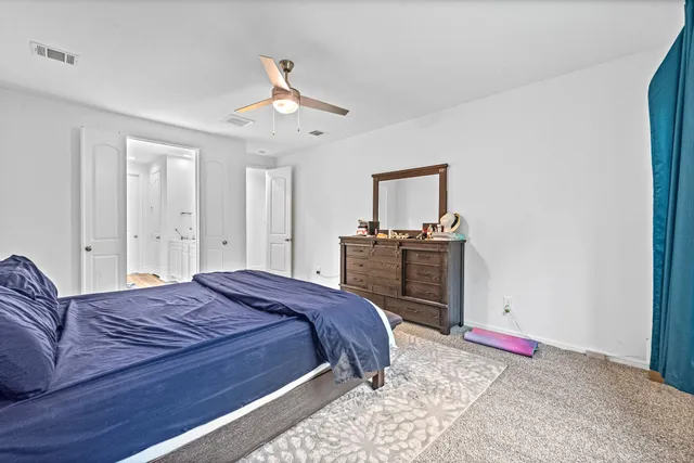 a bedroom with a bed and dresser