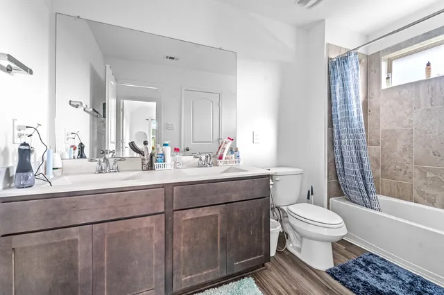 a bathroom with a sink toilet and shower