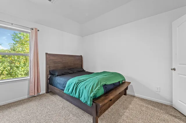 a bedroom with a bed and a window