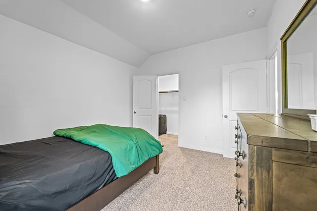 a bedroom with a bed and a desk