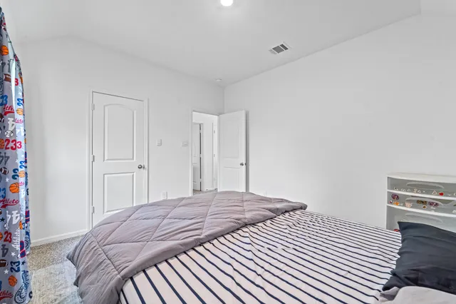 a bedroom with a bed and a book shelf