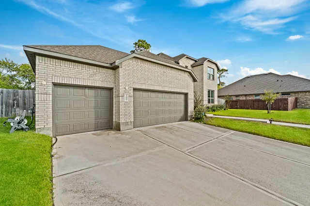 a view of a house with a yard and a garage