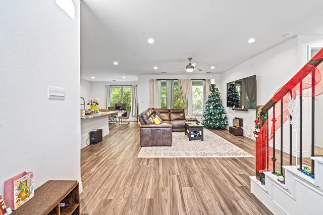 a living room with furniture and a wooden floor