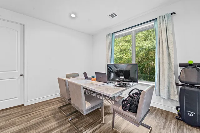 a view of a dining room with furniture window and wooden floor
