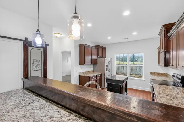 a living room with furniture a fireplace and a chandelier