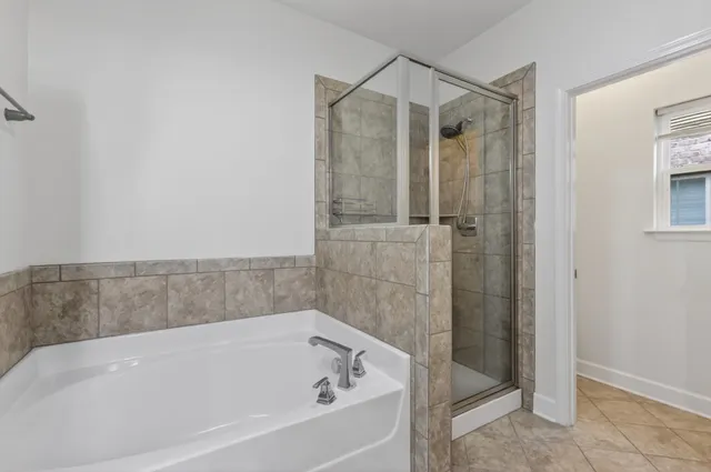 a bathroom with a bathtub and shower