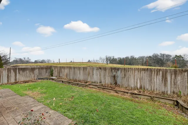 a view of a backyard with a fence
