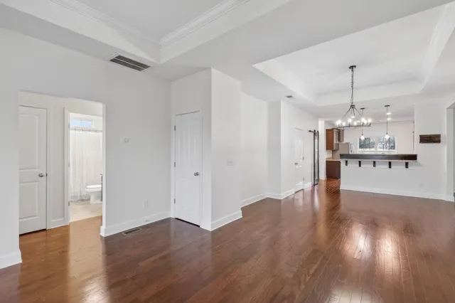 a view of a kitchen with wooden floor and a window