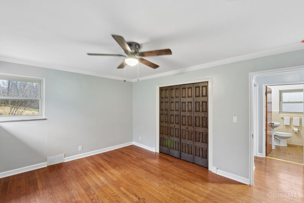 5258 Shepherd Road Cincinnati, OH 45223 - Photo 22 of 43 Here is Bedroom 1! Features include a Lighted Ceiling Fan, Vinyl Windows, Wood Flooring, and a closet.