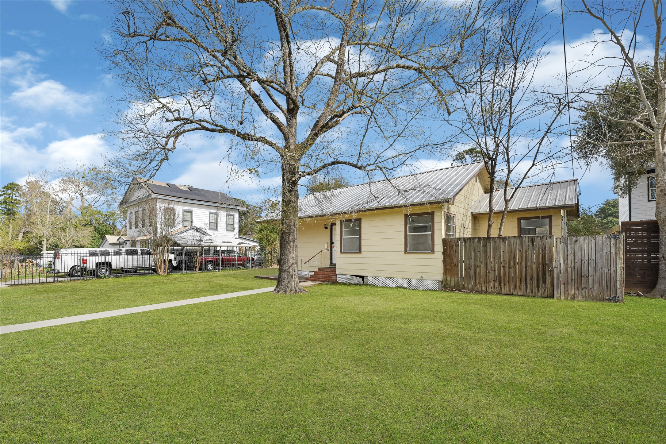 1202 North Roberson Street Conroe, TX 77301 - Photo 49 of 50 Backyard view with detached garage and lawn