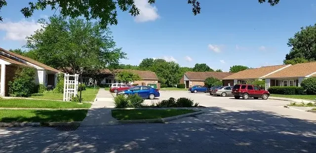 a view of a house with a garden and pathway