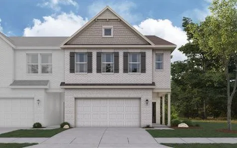 a front view of a house with a garden and trees