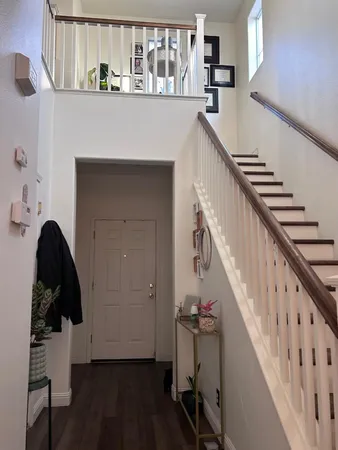 a view of entryway and hall with wooden floor