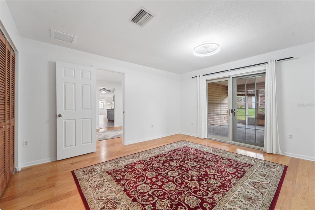 2007 Golf View Drive Dunedin, FL 34698 - Photo 17 of 39 a view of a bedroom with wooden floor and window