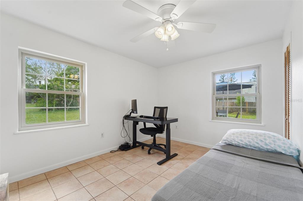 2007 Golf View Drive Dunedin, FL 34698 - Photo 21 of 39 a bedroom with furniture and a window