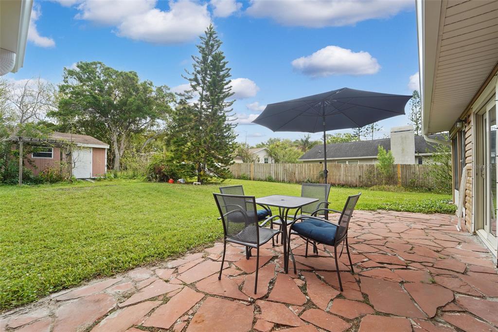 2007 Golf View Drive Dunedin, FL 34698 - Photo 27 of 39 a view of a patio with table and chairs under an umbrella