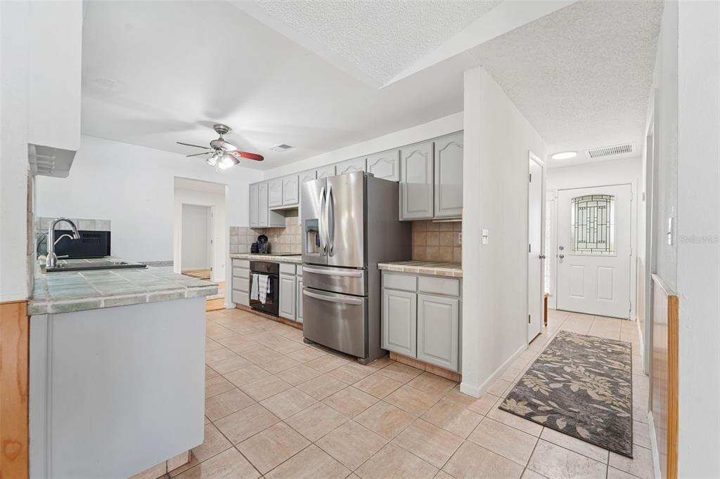 2007 Golf View Drive Dunedin, FL 34698 - Photo 7 of 39 a kitchen with cabinets and stainless steel appliances