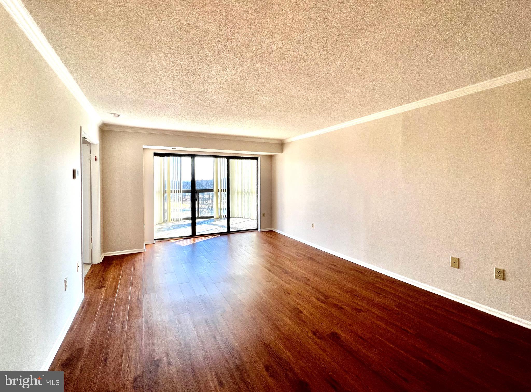 15115 Interlachen Drive, Unit 701 Silver Spring, MD 20906 - Photo 9 of 48 Living room with sliding doors to the sunroom