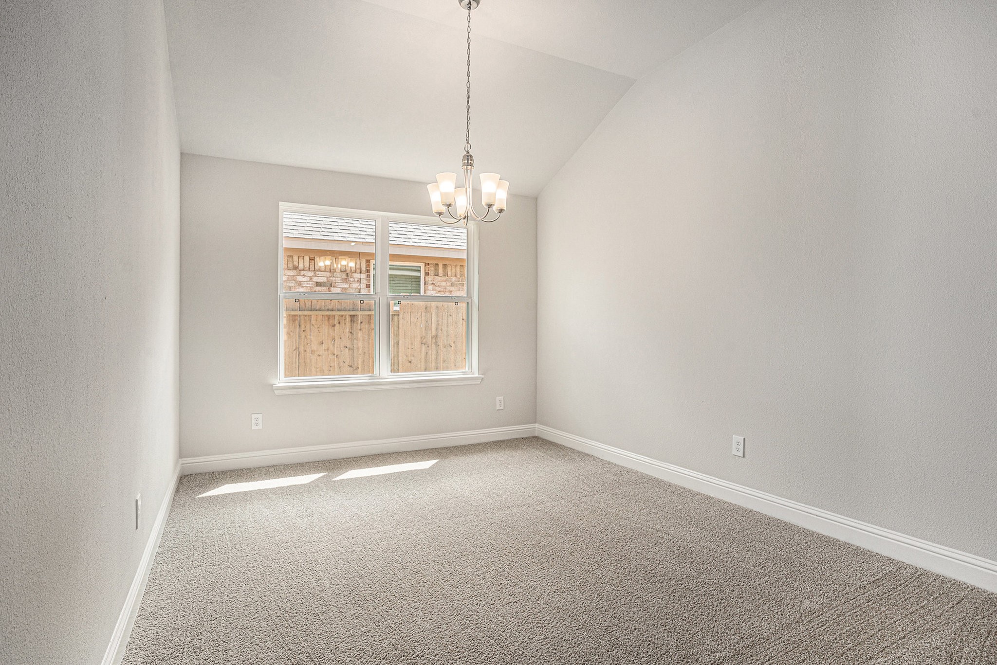 33 Greenbriar Loop Angleton, TX 77515 - Photo 3 of 18 an empty room with windows and chandelier fan
