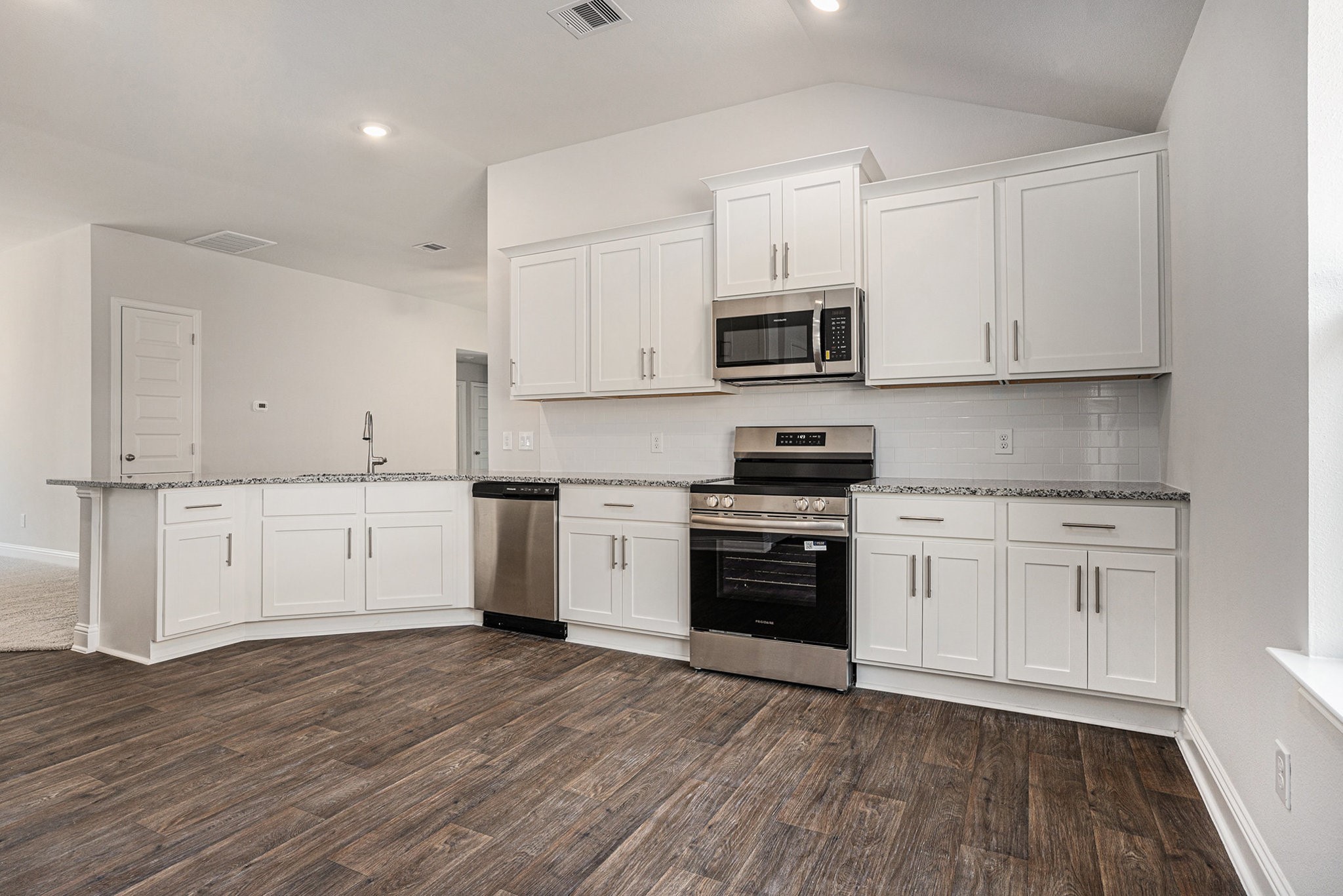 33 Greenbriar Loop Angleton, TX 77515 - Photo 4 of 18 a kitchen with stainless steel appliances granite countertop a stove a sink and white cabinets