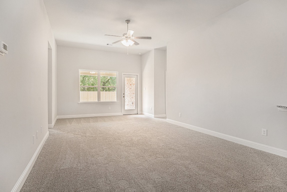 33 Greenbriar Loop Angleton, TX 77515 - Photo 8 of 18 an empty room with windows and chandelier fan