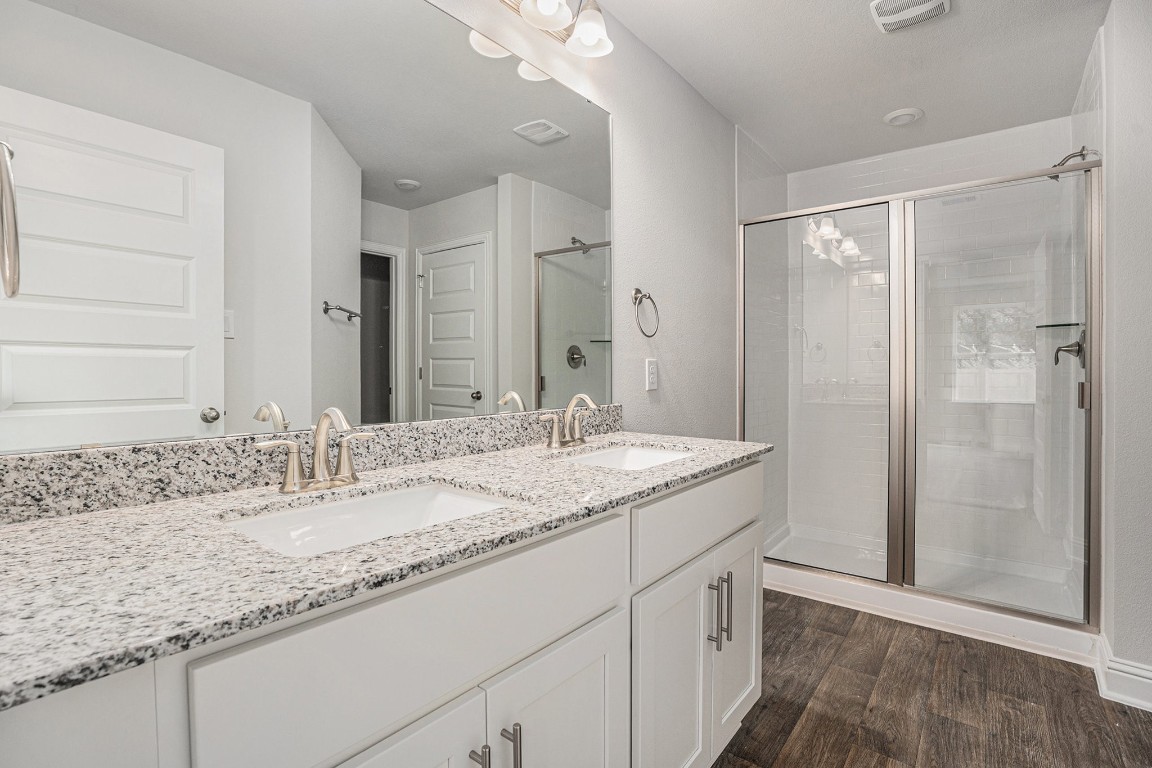 33 Greenbriar Loop Angleton, TX 77515 - Photo 9 of 18 a bathroom with a granite countertop sink and a mirror