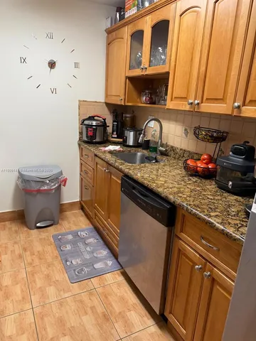 a kitchen with a sink a stove and cabinets