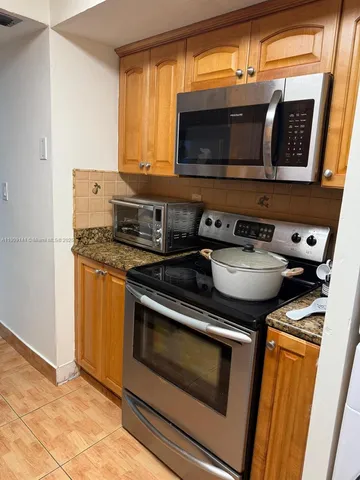 a kitchen with a stove and a microwave
