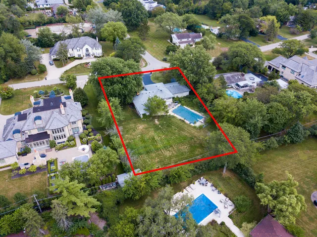an aerial view of residential house with outdoor space and swimming pool