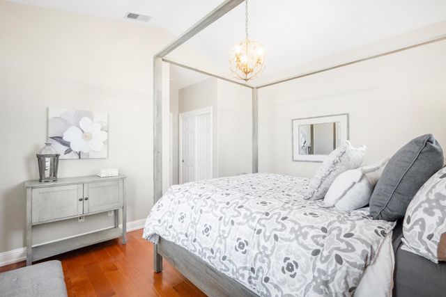 a bedroom with a bed and a chandelier