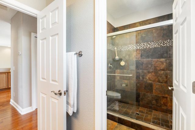 a bathroom with a glass shower door