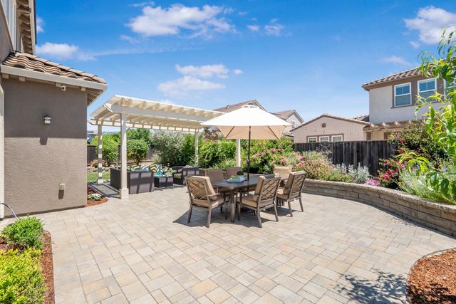 a view of a patio with table and chairs and potted plants