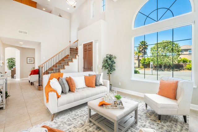 a living room with furniture and a potted plant