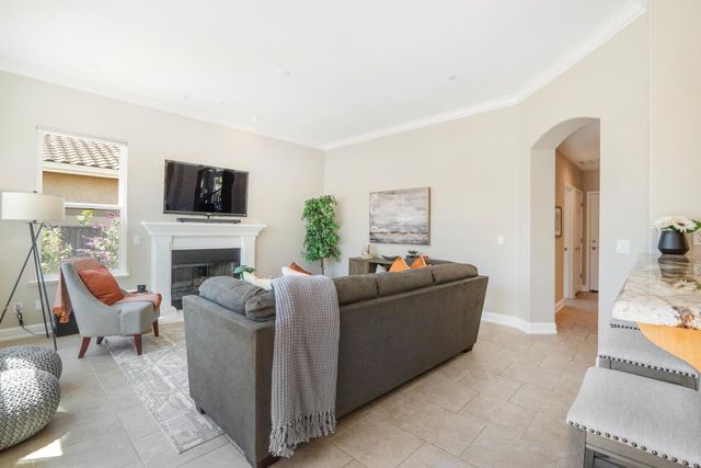 a living room with furniture a flat screen tv and a fireplace