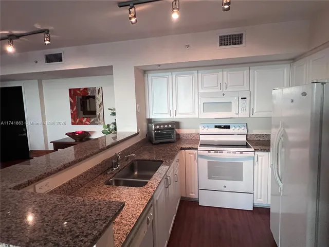 a kitchen with a stove microwave and refrigerator