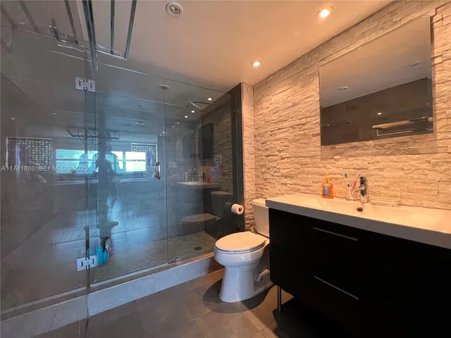 a bathroom with a sink toilet and shower