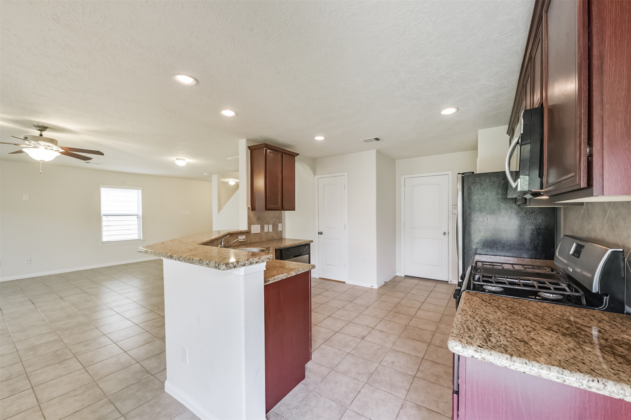 2142 Tandy Park Way Houston, TX 77047 - Photo 11 of 35 a kitchen with stainless steel appliances granite countertop a sink stove and refrigerator