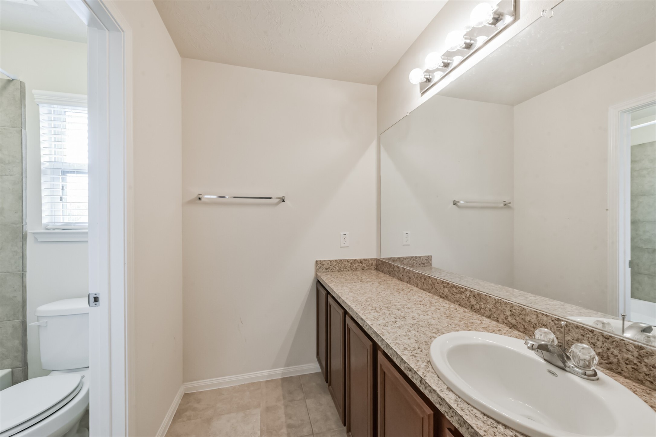 2142 Tandy Park Way Houston, TX 77047 - Photo 28 of 35 a bathroom with a granite countertop sink and a mirror