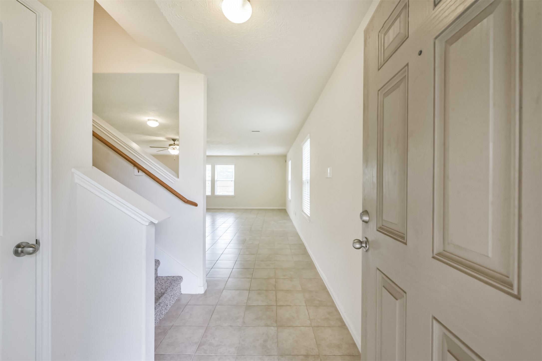 2142 Tandy Park Way Houston, TX 77047 - Photo 3 of 35 a view of a hallway with white walls and stairs