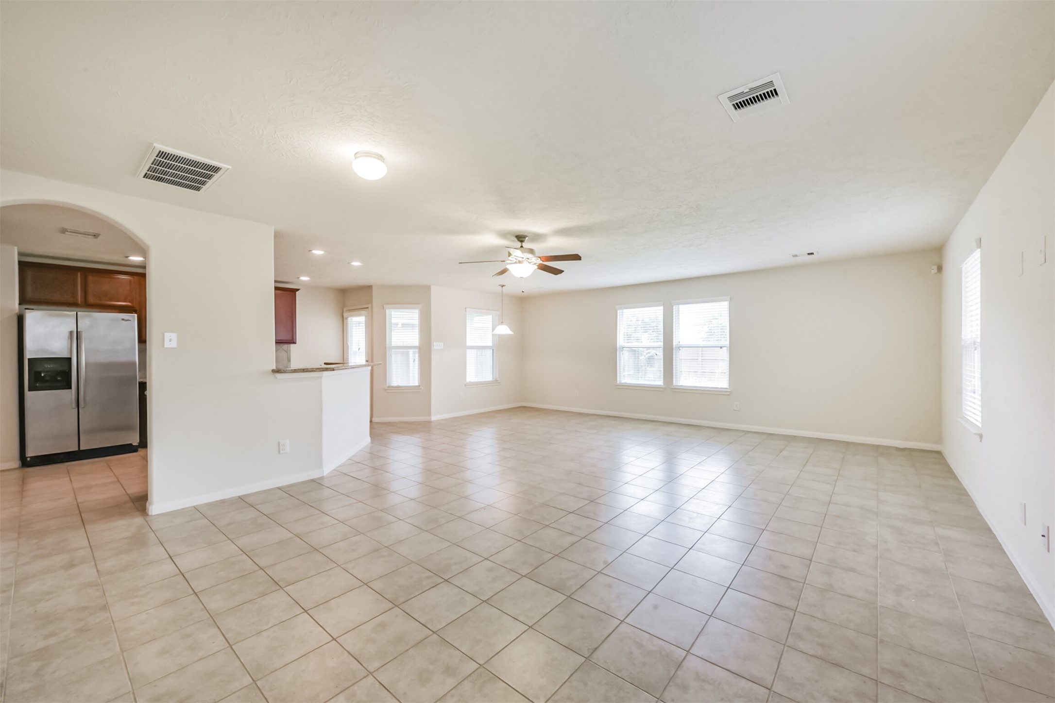 2142 Tandy Park Way Houston, TX 77047 - Photo 4 of 35 wooden floor in an empty room with a kitchen