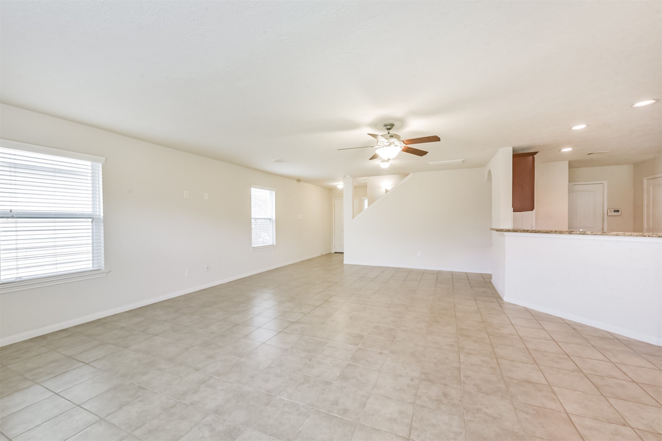2142 Tandy Park Way Houston, TX 77047 - Photo 6 of 35 an empty room with chandelier fan and windows