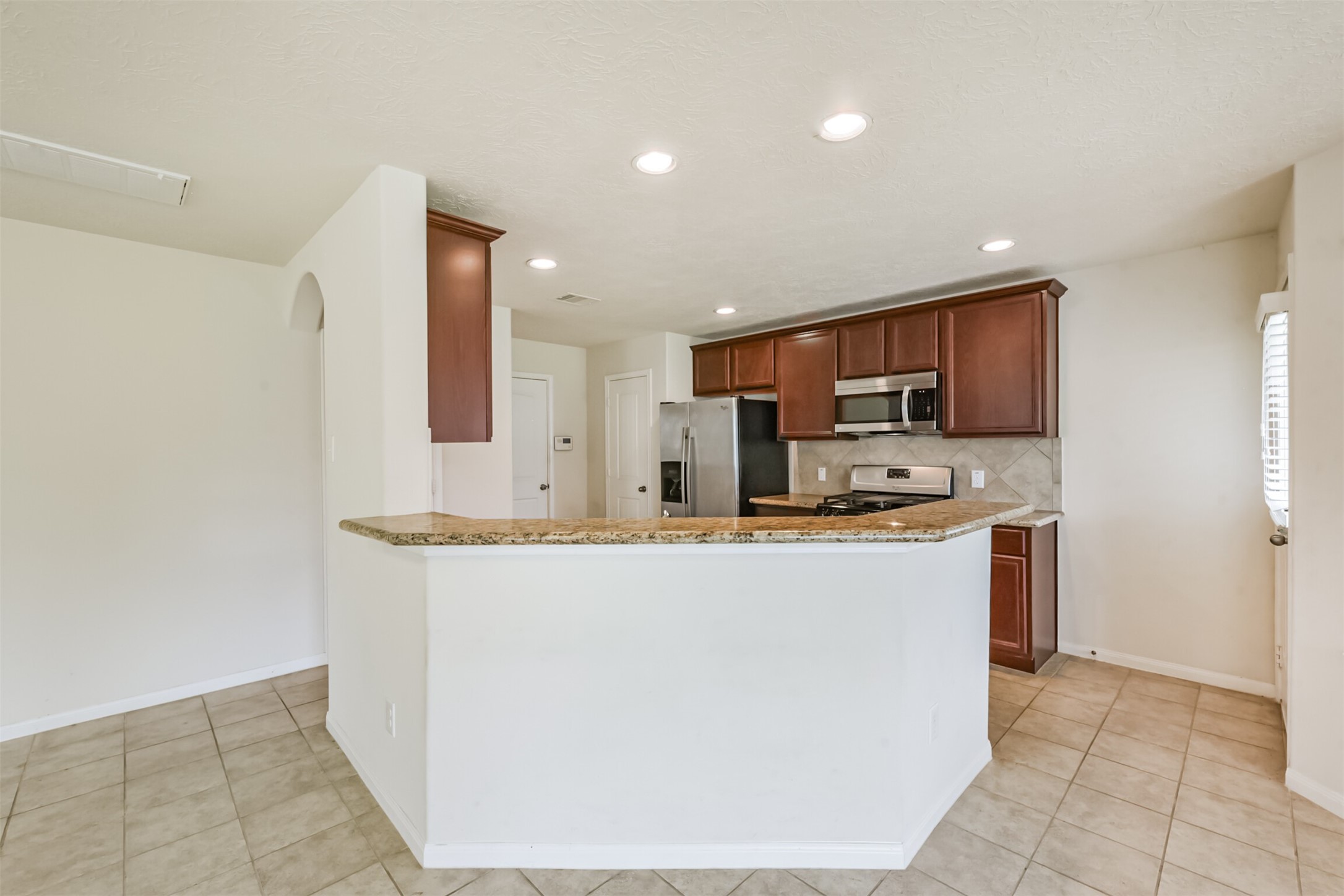 2142 Tandy Park Way Houston, TX 77047 - Photo 9 of 35 a kitchen with stainless steel appliances a refrigerator sink and microwave