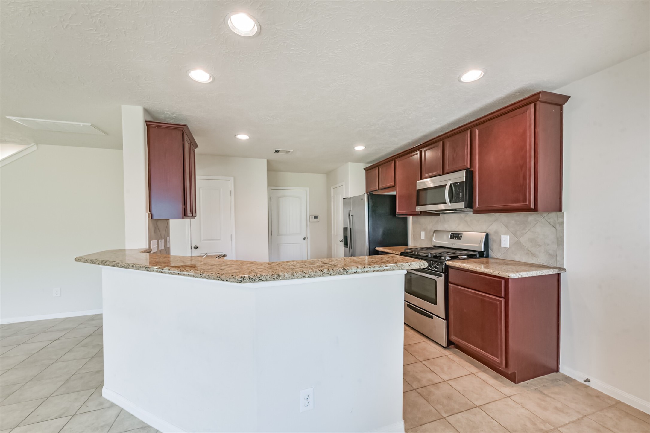 2142 Tandy Park Way Houston, TX 77047 - Photo 10 of 35 a kitchen with stainless steel appliances granite countertop a sink stove and cabinets