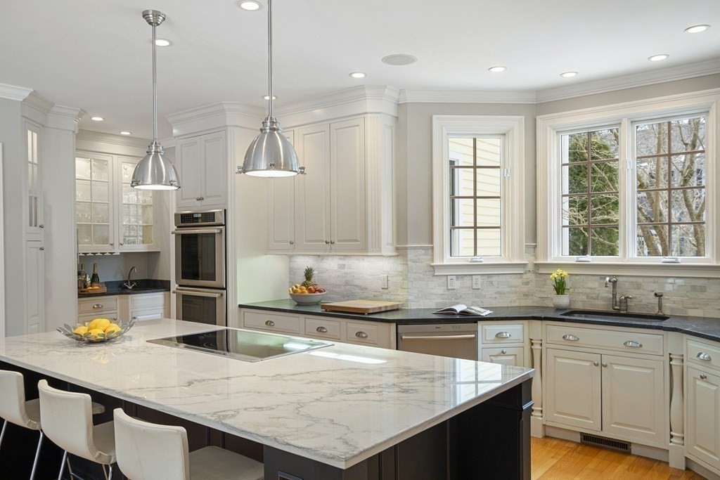 61 Garfield Road Concord, MA 01742 - Photo 12 of 33 a kitchen with granite countertop a sink a center island and stainless steel appliances