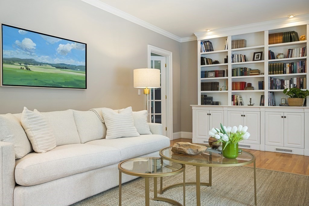 61 Garfield Road Concord, MA 01742 - Photo 14 of 33 a living room with furniture potted plant and a book shelf