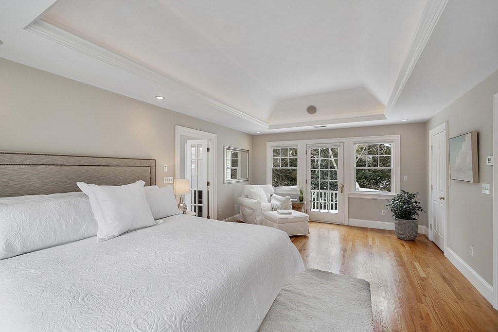 61 Garfield Road Concord, MA 01742 - Photo 18 of 33 a spacious bedroom with a bed and wooden floor