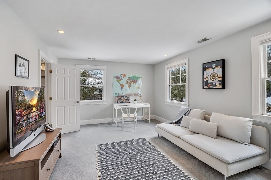 61 Garfield Road Concord, MA 01742 - Photo 21 of 33 a living room with furniture and a flat screen tv