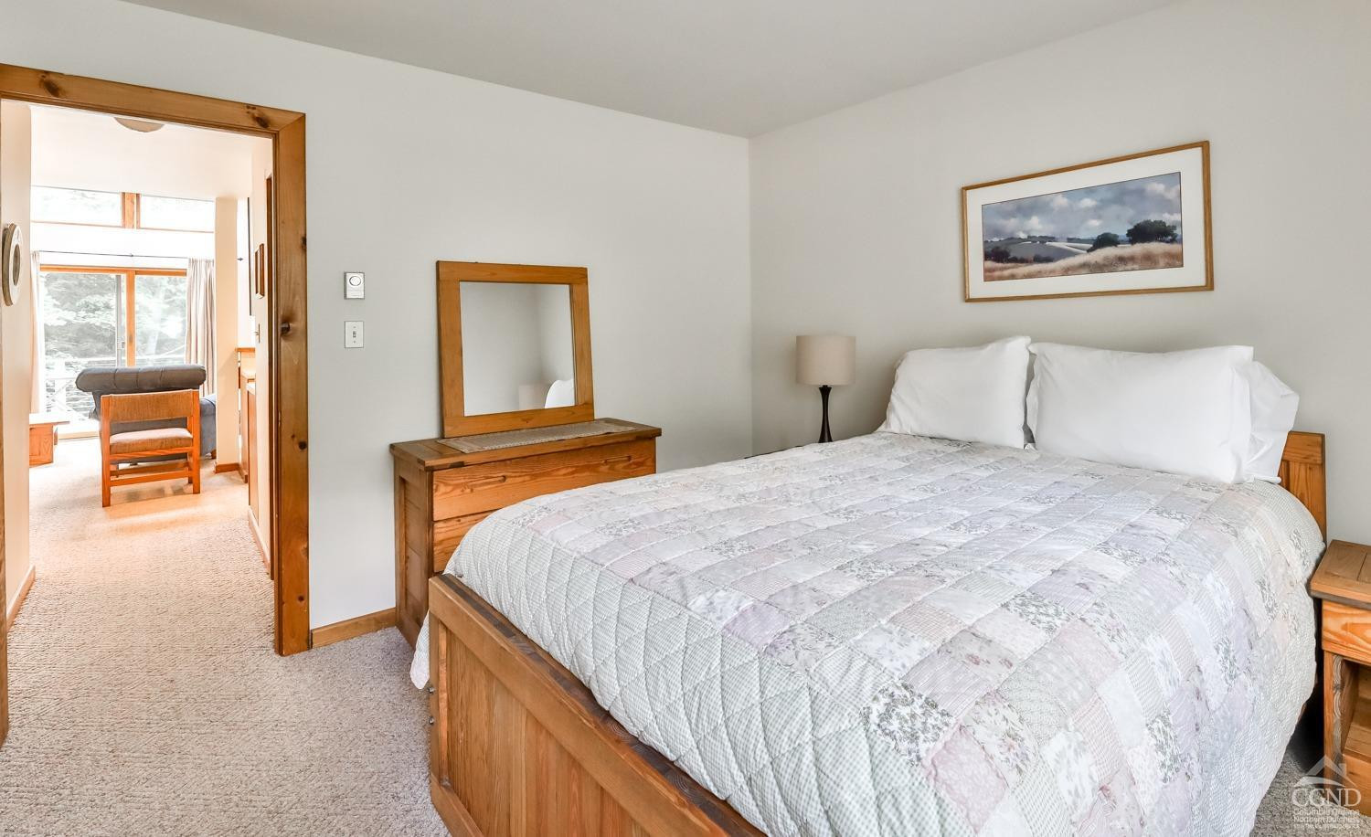 91 Windham Ridge Road, Unit 18B Windham, NY 12496 - Photo 18 of 30 a bedroom with a bed and a painting on the wall